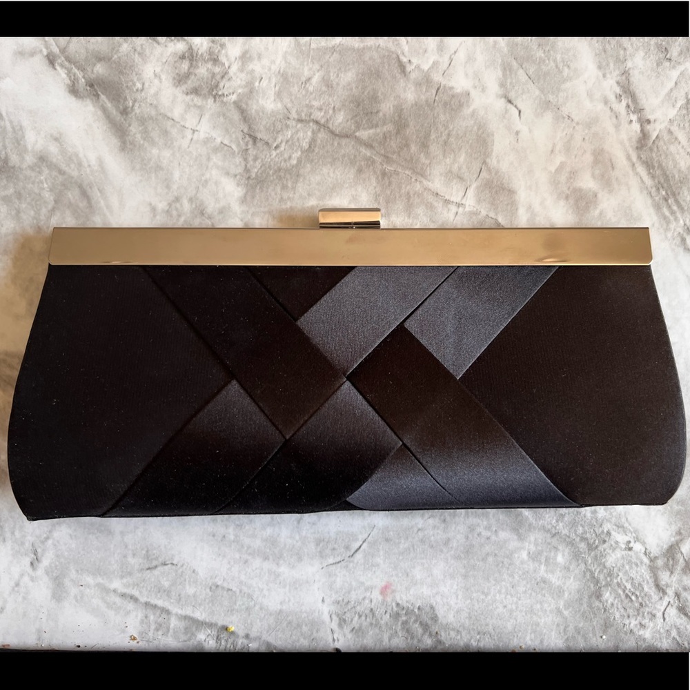 Black Clutch. Closes w clasp and has removable chain strap.